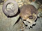 Human skull and an iron currency bracelet found at the bottom of Iroungou cave in Gabon