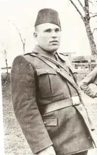 A man in military uniform, wearing a fez.