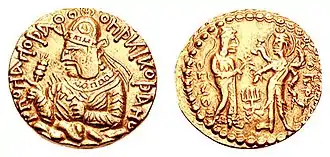 Coinage of Kushan ruler Huvishka with, on the reverse, the divine couple Ommo ("ΟΜΜΟ", Umā) holding lotus flower, and Oesho ("ΟΗϷΟ", Shiva) with four arms holding attributes. Circa 150-180 CE.