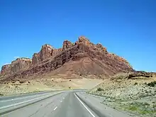 A mountain made from two layers of sandstone, the lower layer is a light color, while the upper layer is dark red.