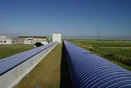 View of the 3-km-long Virgo west arm (right pipe). The tube on the left, which is 150 metres long, hosts the mode-cleaner cavity which is used to spatially filter the laser beam.