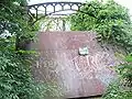 This 2007 photograph shows a steel plate across the east portal of the Schell bridge. A similar one is on the west portal, since the bridge deck is rusting through. The top of the plate reads "Where the sidewalk ends." The plate has a "NO TRESPASSING" sign bolted to it as well.