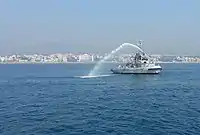 INS Gaj (A51) spouting water cannon.