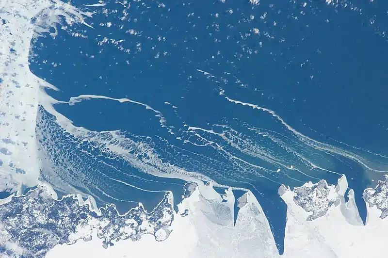 The Potawatomi Islands in February as the ice is breaking up. The edge of the Garden Peninsula to the north is on the left, and the edge of the Door Peninsula to the south is on the right.