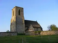 A large tower to the left in three stages with a plain parapet and the much smaller body of the church to the right