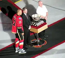 Iignla poses beside a large silver chalice during a pre-game ceremony.