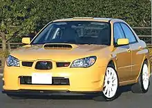 Subaru Impreza WRX STI spec C Type RA-R, a high-performance variant of the standard Subaru Impreza sedan. This photo shows the front of the car, which is yellow with white wheels.