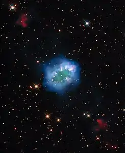 The interaction of two doomed stars has created this spectacular ring adorned with bright clumps of gas — a diamond necklace of cosmic proportions.