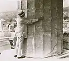 Base of a Doric column, Parthenon, embraced by Frank G. Carpenter