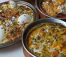 Hyderabadi biryani (on the left) served with other Indian dishes.