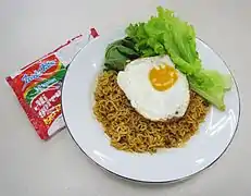 Indomie Mi goreng served with fried egg and vegetables