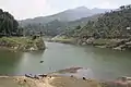 Group of fishermen with their boats by the Kulekhani reservoir.