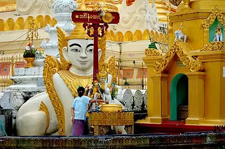 The planetary post for Tuesday, associated with the lion, at the Shwedagon Pagoda. A Burmese sphinx (Manussiha) statue stands in the background.