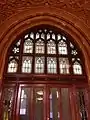 Prudential Assurance, Holborn Bars, Gothic style Woodwork and glazing using simple patterns and grey coloured and plain glass, with dark orange faience surround, in main entrance (c.1901)