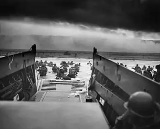 Soldiers wading ashore from landing craft on D-Day