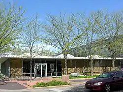 One-story building with spherical protrusions from the roof; leafless trees are in front of it