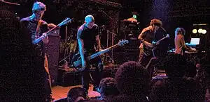 Four members of Isis onstage, playing their instruments