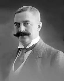 Black and white photo of the headshot of a middle aged man