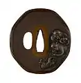 Edo-era tsuba sword guard depicting adult and young monkeys.