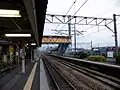 A view of the station platforms. The Tosu Freight Terminal can be seen to the right.