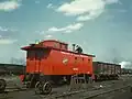 A railway worker putting the finishing touches on a rebuilt caboose on the RIP tracks at Proviso yard, Chicago