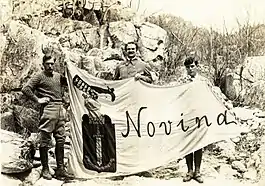 Yankovsky with sons holding banner