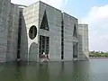 Image 29Jatiyo Sangsad Bhaban is the National Assembly Building of Bangladesh, located in the capital Dhaka. It was created by architect Louis I. Kahn and is one of the largest legislative complexes in the world. It houses all parliamentary activities of Bangladesh. This photo offers a close view of a section of the parliament building.Photo Credit: justinstravels