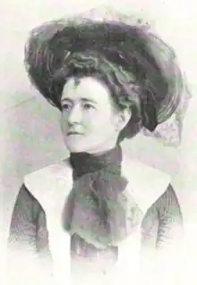 A white woman wearing a large hat