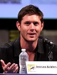 A man with brown hair wearing a black shirt.