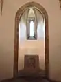 Presbytery in the chapel with a stone altar decorated with the coat of arms of Jan of Jenštejn