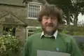 Jim Ridge, in front of his cottage on 3 September 1993, reading the letter he wrote to Time Team. Ridge died on 21 January 2003