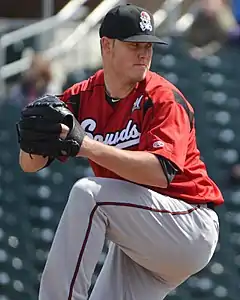 A baseball player in red and gray