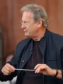 conductor John Eliot Gardiner at work, facing to the left