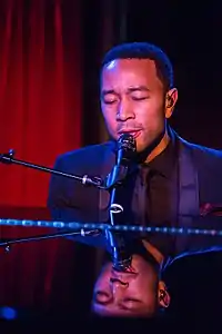 John Legend playing a piano