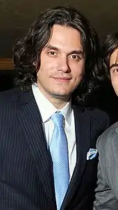 The singer John Mayer wearing a pinstripe jacket and a necktie