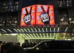 Entrance of a theater, with the film's poster showcased above.