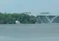 The lighthouse and the Woodrow Wilson Bridge, seen from the bank of the Potomac River at Belle Haven