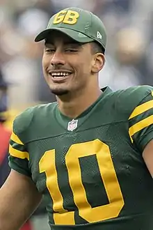 Love in uniform wearing a Packers hat