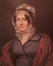 Half-length portrait of a middle-aged woman with bonnet and expensive burgundy shawl