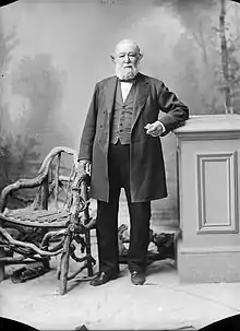 Formal standing portrait of an older man