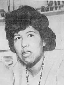 Black and white photograph of a Native American woman wearing a beaded necklace.