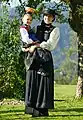 Woman in blackmith costume with daughter in redmith costume