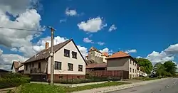 Kámen Castle above the village