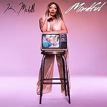 An image of K. Michelle standing in front of a stool with a television on top of it; the singer's name and single's title are also on the cover.