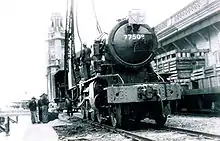 An ex-British Army WD Austerity 2-8-0 locomotive delivered to Hong Kong in 1947 for KCR British Section. The Clock Tower is visible in the background.