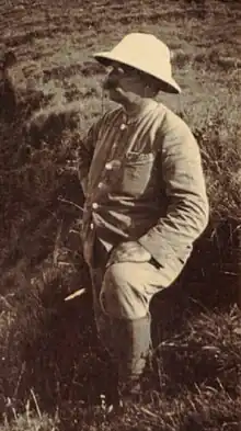 Black and white portrait of a middle-ages man wearing a white helmet