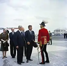 Major-General Sir Julian Gascoigne (right), wearing General officer's full dress as Governor of Bermuda (with Minister for Foreign Affairs the Earl of Home, Prime Minister Harold Macmillan, British Ambassador to the United States Sir David Ormsby-Gore, and United States President John F. Kennedy) in 1962.