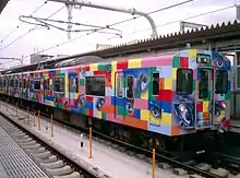 Kakogawa Line 2-car 103–3550 series set M1 with Train with eyes livery by Tadanori Yokoo, October 2005