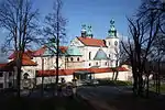 Church with white walls, red roof and copper-covered domes