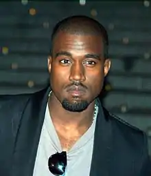 A picture of Kanye West looking into the camera at a festival.